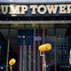 Activists raise their paint rollers as they paint a new Black Lives Matter mural outside of Trump Tower on Fifth Avenue on July 9, 2020 in New York City.